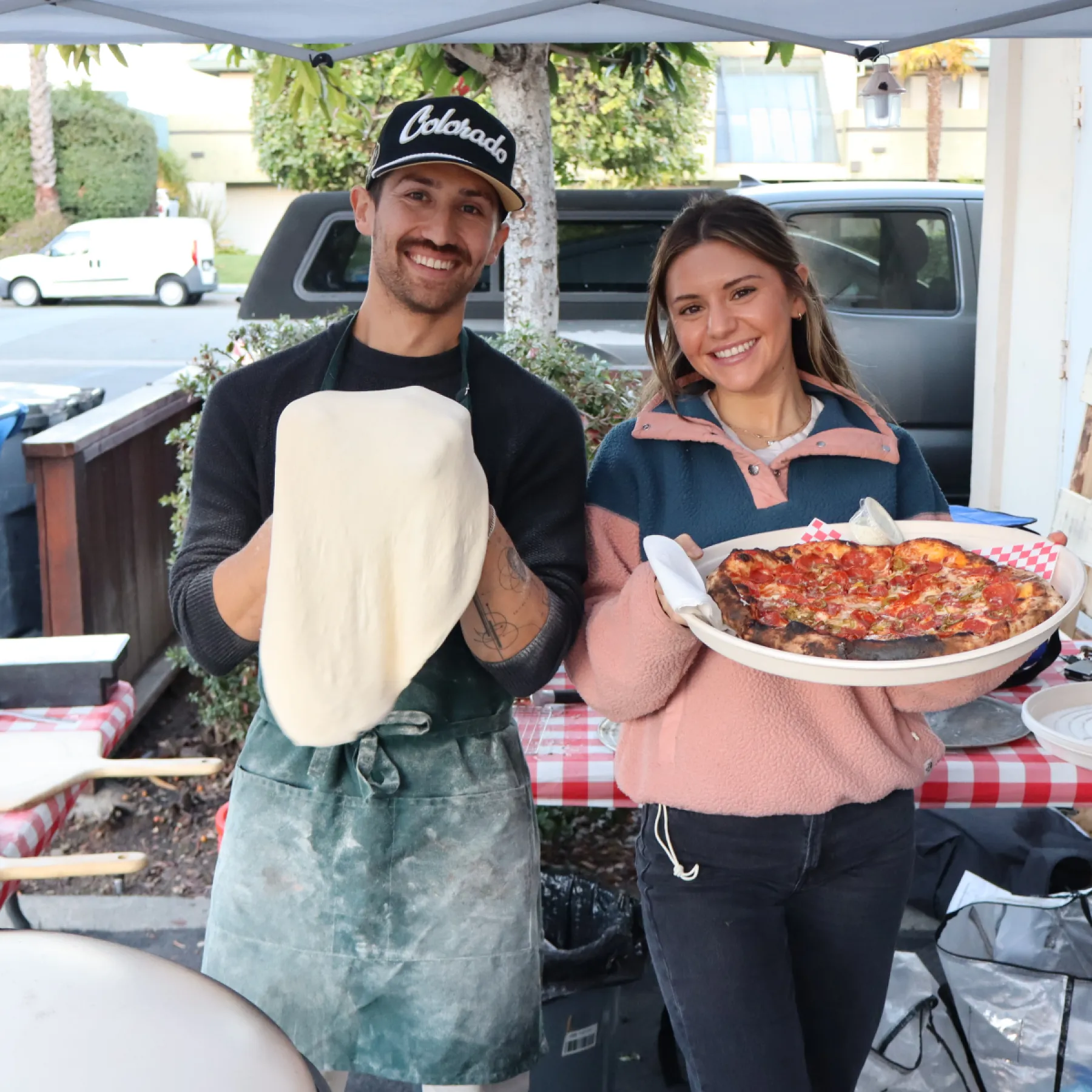 Anna and Jeff Fox with dough and a pepperoni pizza